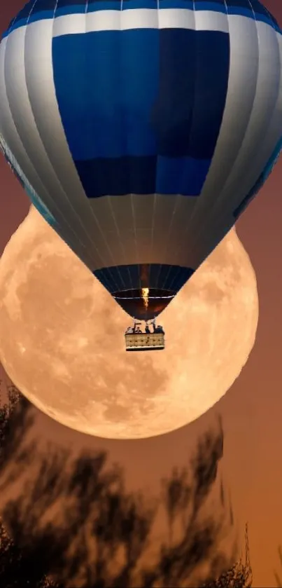 Hot air balloon rises in front of a full orange moon.