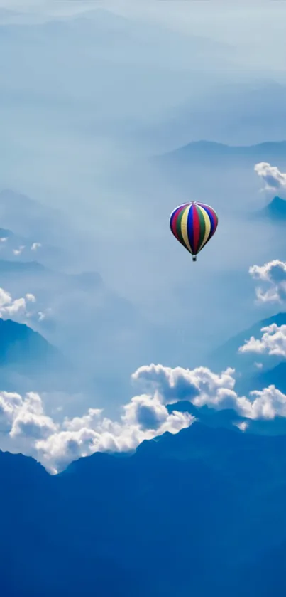 Hot air balloon floating over cloudy mountains.