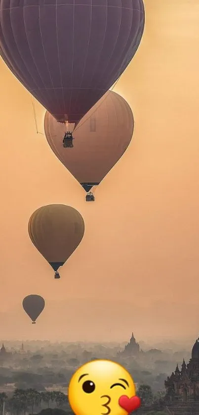 Hot air balloons at sunset over temples with a warm orange sky.