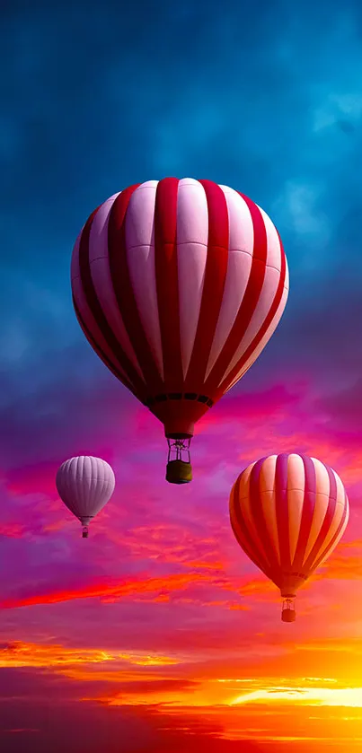 Colorful hot air balloons float against a vibrant sunset sky.