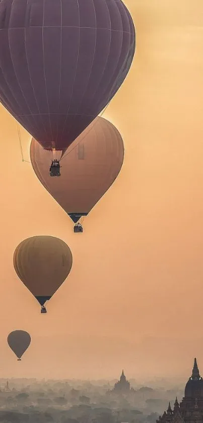 Hot air balloons float over ancient temples at sunrise, creating a serene mobile wallpaper.