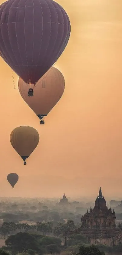 Hot air balloons floating over temples at sunrise.