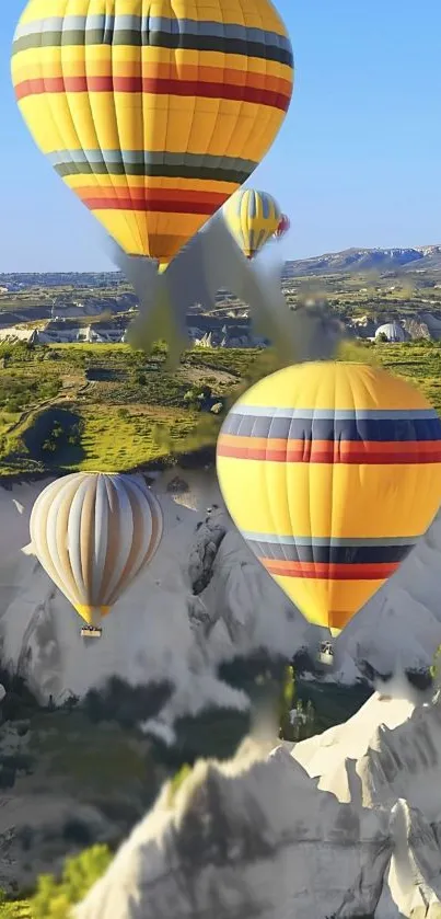 Hot air balloons over Cappadocia landscape.