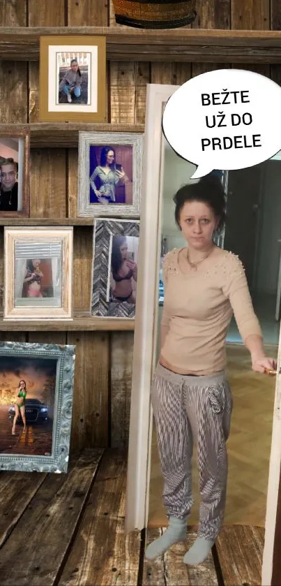 Woman stands at door with framed photos on wooden wall background.