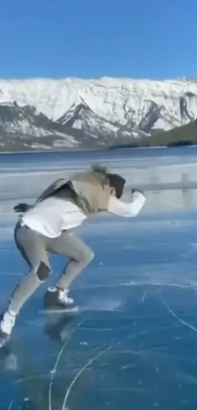 Person ice skating on a clear frozen lake with snowy mountains.