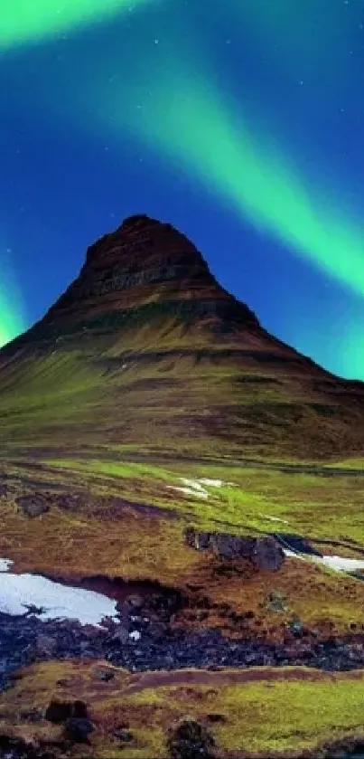 Icelandic landscape with Northern Lights and waterfall at night.