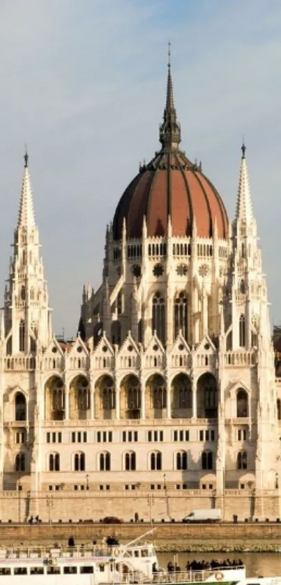 Mobile wallpaper of iconic parliament building by a river with blue sky.