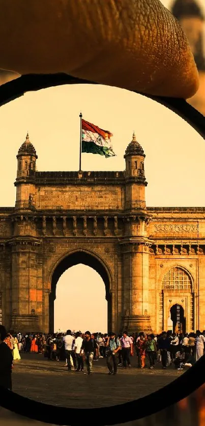 Gateway of India through a lens with a flag in the golden hour.