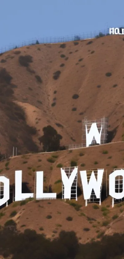 Mobile wallpaper with iconic Hollywood Sign on brown hillside.