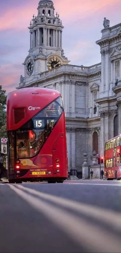 Red London buses and historic architecture at sunset.