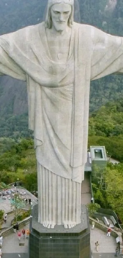 Christ the Redeemer statue amid lush greenery.