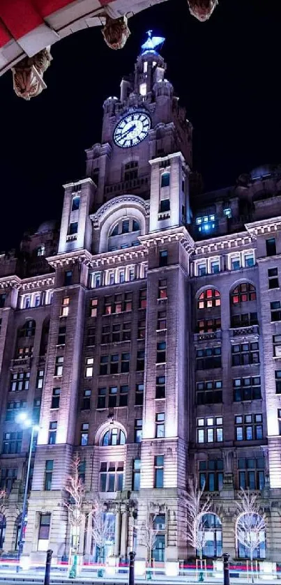 Historic building beautifully lit at night with archway framing view.