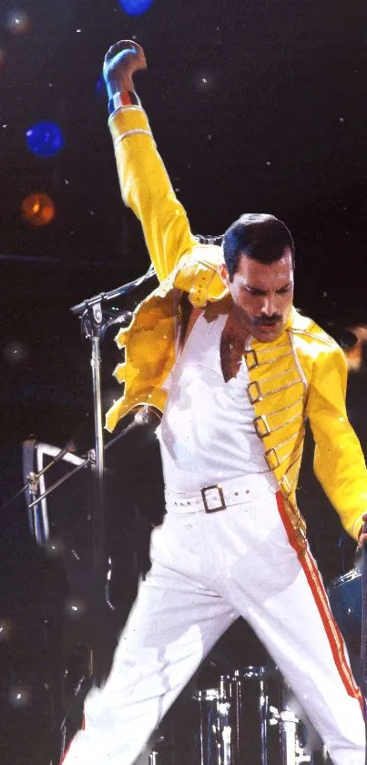 Iconic performer in yellow jacket striking a powerful pose on stage.