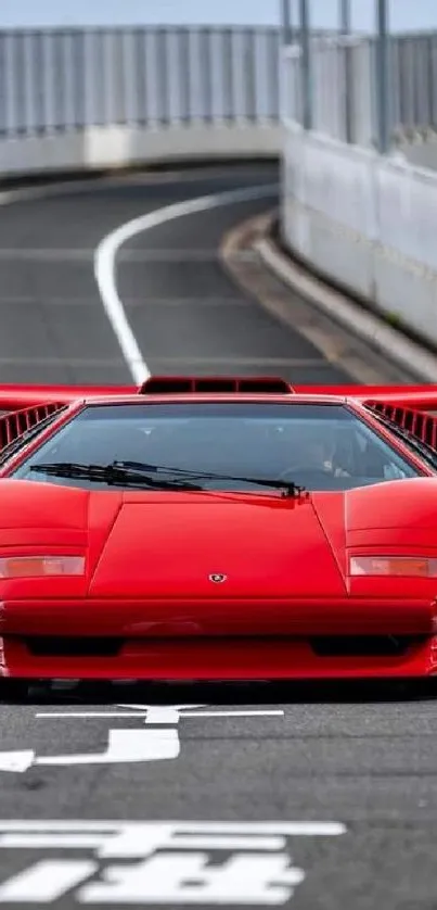 Iconic red sports car on empty road.