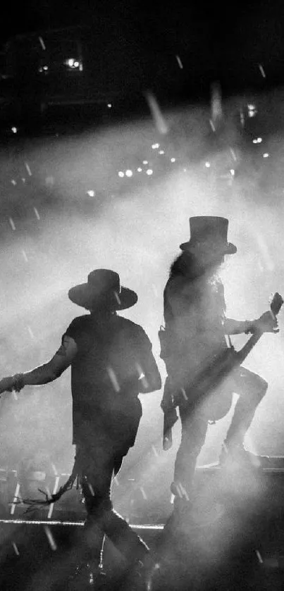 Silhouette of two rock musicians performing on stage with dramatic lighting.