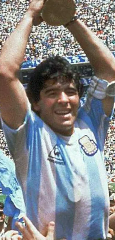 Player lifting trophy in crowded stadium, celebrating victory.