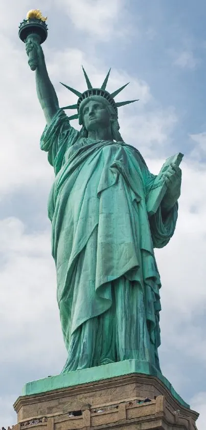 Statue of Liberty against a bright blue sky, iconic symbol of freedom.