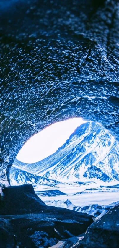 Icy cave opening with mountain view in blue tones.