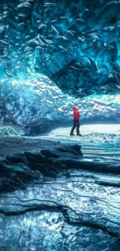 Adventurer explores stunning icy blue cavern.