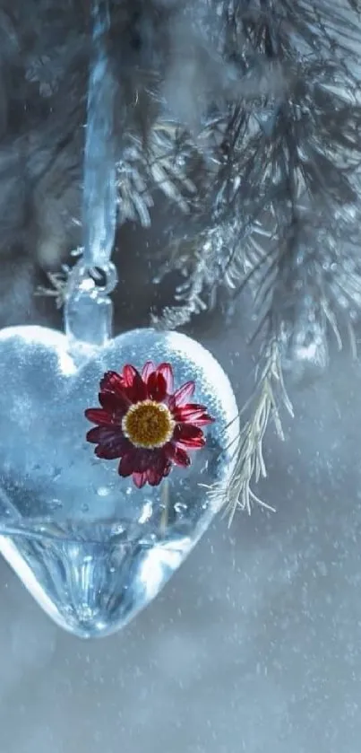 Icy heart ornament with a red flower in winter setting.