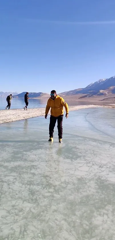 Person ice-skating on a frozen lake with mountains in the background.