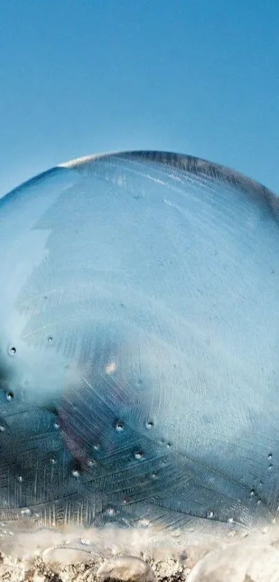 Frozen icy sphere against a blue sky mobile wallpaper.