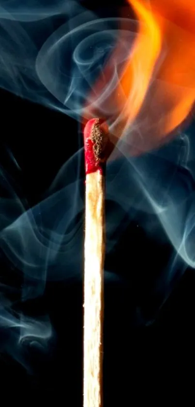 Burning matchstick with flames and smoke on a dark background.