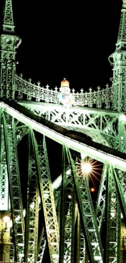 Illuminated bridge at night with intricate details.