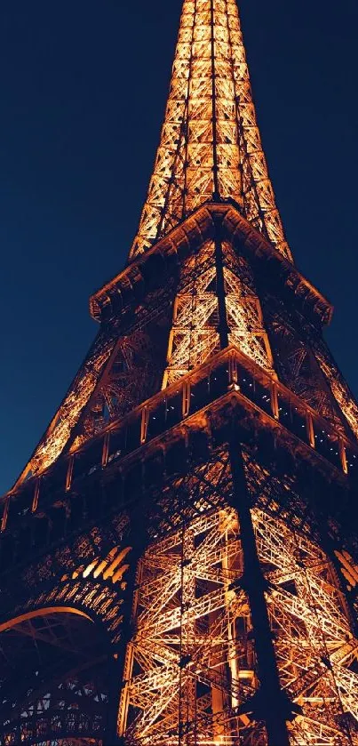 Eiffel Tower illuminated against a dark blue night sky.