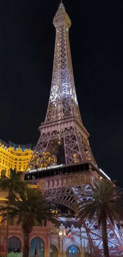 Night view of the illuminated Eiffel Tower in Paris with vibrant city lights.