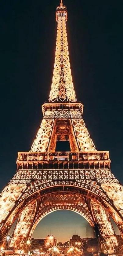 Elegant illuminated Eiffel Tower at night with glowing lights.