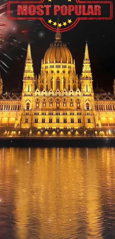 Wallpaper of illuminated Gothic building with fireworks and reflection on water.