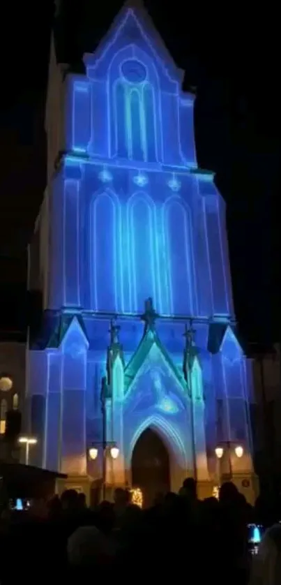 Gothic tower illuminated in blue at night