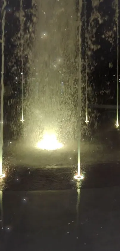 Luminous water fountain glowing at night with ambient lights.