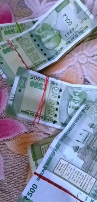 Indian currency notes on a floral background.