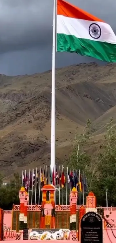 Indian flag flies over mountainous terrain, capturing patriotic essence.