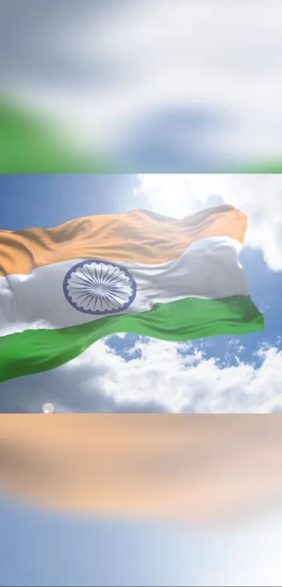 Indian flag waving against blue sky with clouds.