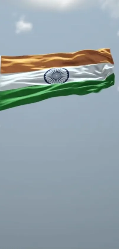 Indian flag soaring against a clear blue sky, symbolizing national pride.