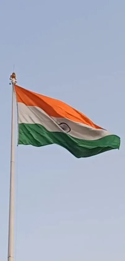 Indian flag waving against a clear blue sky.