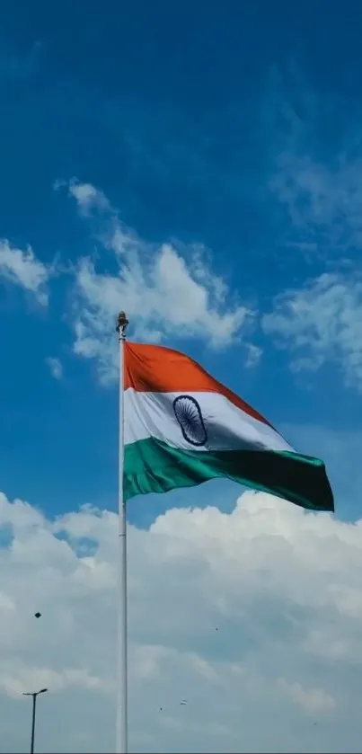 Indian flag waving under a blue sky.