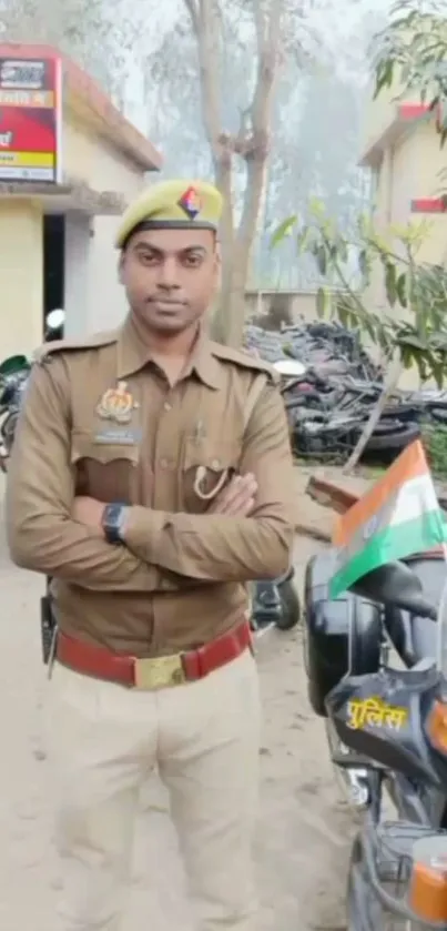 Indian police officer in uniform standing with Indian flag visible.