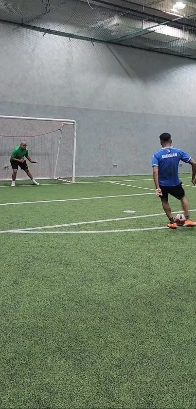 Indoor soccer match with player shooting at goal.