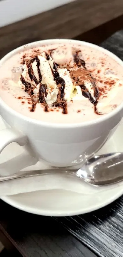 Cup of hot chocolate with cream and chocolate sauce on a table.