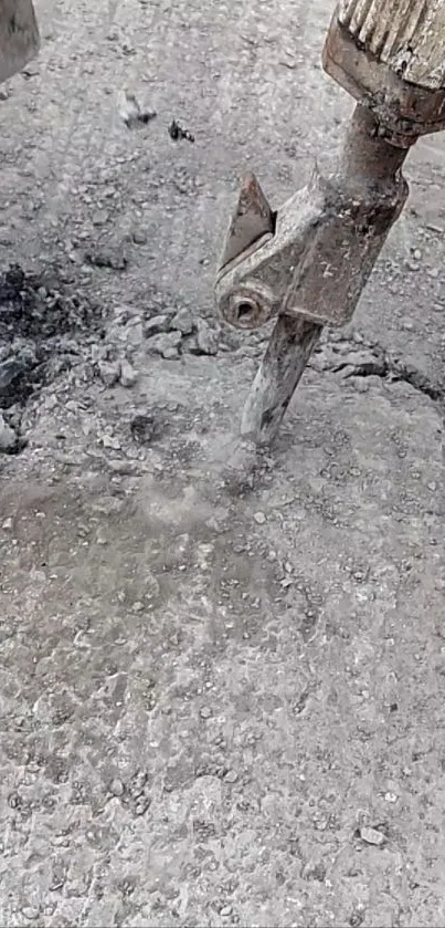 Concrete drilling tool breaking rough surface.