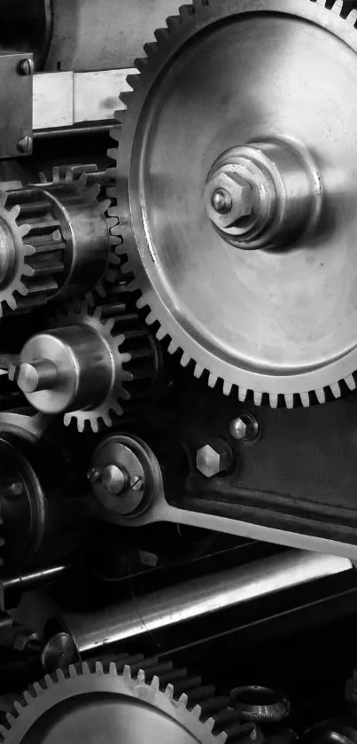 Close-up of intricate industrial gears in black and white.