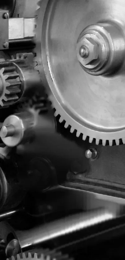 Black and white image of detailed metal gears and cogs.