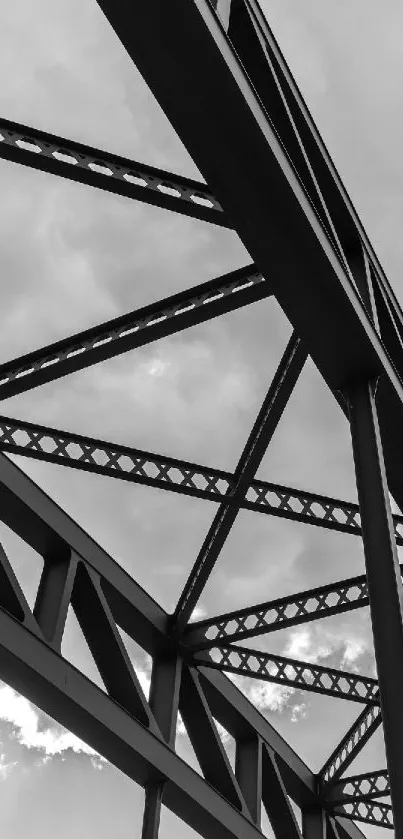 Black and white image of a steel bridge structure in an urban setting.