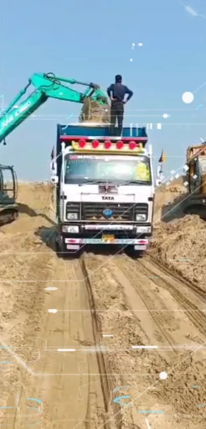 Excavator and truck in a sandy work site under a blue sky.