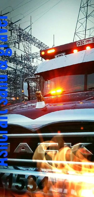 Industrial truck under power lines at dusk.