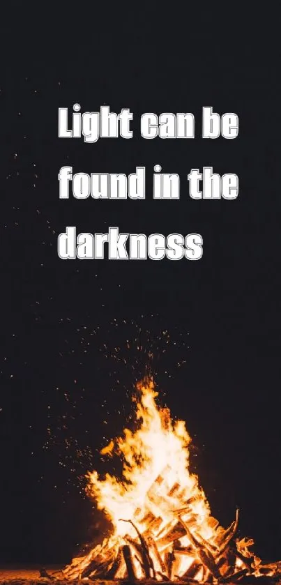 Campfire in darkness with inspirational quote.